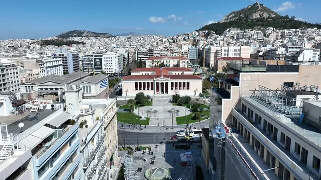 Aerial drone cinematic video of famous Korai street in front of Athens neoclassic trilogy, Academy, University and Library, Attica, Greece