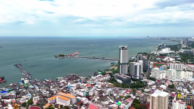 Drone flying over the urban landscape and coastal cityscape of Si Racha, Gulf of Thailand.