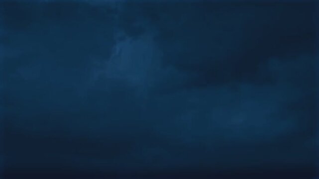 Lightning flashes in the dark blue night sky during a heavy storm