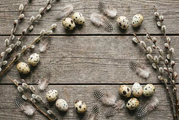 Easter flat lay background with quail eggs and pussy willow © saikorn