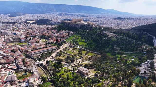 Aerial drone cinematic video of Ancient Agora or Forum of Athens historic centre built below Acropolis hill, Attica, Greece