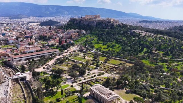 Aerial drone cinematic video of iconic Temple of Hephaestus in Ancient Agora of Athens historic centre built below Acropolis hill , Attica, Greece