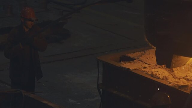 Men workers heat and grind details. Metal production process in a metallurgical factory. Modern metallurgical factory. Red hot metal in a modern factory. Men workers heat and grind details. Steelworks