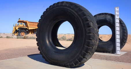 Obraz premium Massive tires used on a mining haul truck pictured in background