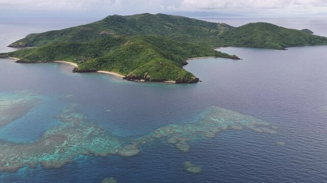 The beautiful island of Makogai in Fiji is fringed by a healthy coral reef. Fiji's reefs support high marine biodiversity and are a popular destination for scuba divers and snorkelers.
