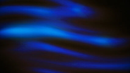 Fototapeta premium Blue light streaks create a dynamic wave pattern against a dark background, showing luminous movement and fluid energy.