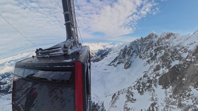 Aiguille du Midi cable car ascending Chamonix snowy mountains