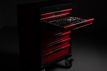 Open red tool chest with organized socket and ratchet tools in workshop
