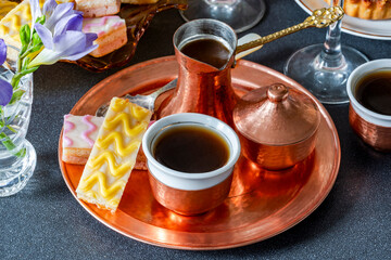 Fototapeta premium Coffee and selection of gourmet cakes set up on a table