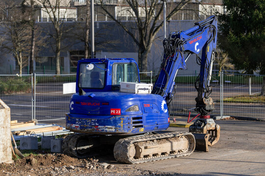 Laxou, France - January 17th 2026 : View on a blue compact crawler excavator Takeuchi TB290-2 for the demolition of a building on a construction site.