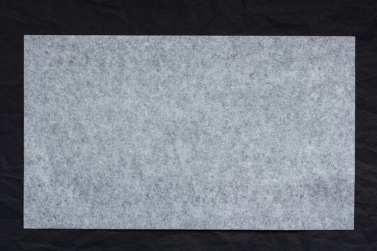 sheet of thin translucent tissue paper on a black background