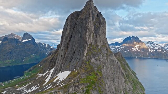 Aerial view of Segla mountain summit and surrounding fjord on Senja Island, Norway. Iconic Arctic peak dominates the rugged northern landscape.