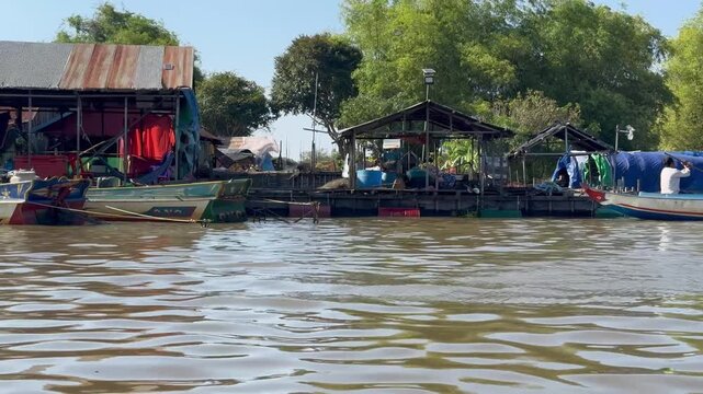 Passing view from a longtail boat through Prek Toal floating village on the Sangker River, between Tonle Sap Lake and Battambang, Cambodia.