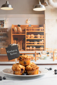 Freshly Baked Blueberry Muffins on a White Countertop in a Bakery