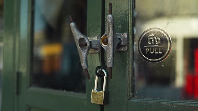 A detailed view of two skateboard chassis knockers and metal studs on a traditional wooden door