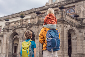 Father with his two sons visiting Chapultepec Castle in Mexico City, enjoying a cultural family...