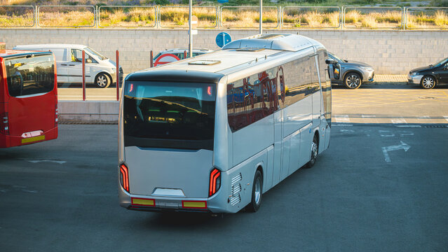 Modern coach bus maneuvering through urban station