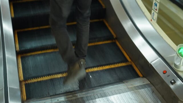 Moving up the escalator with glass sides