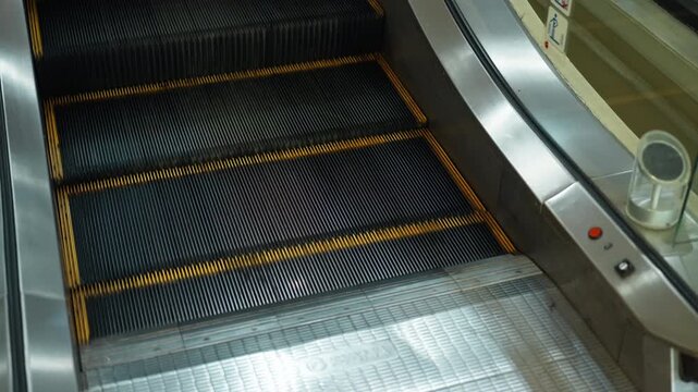 Moving up the escalator with glass sides