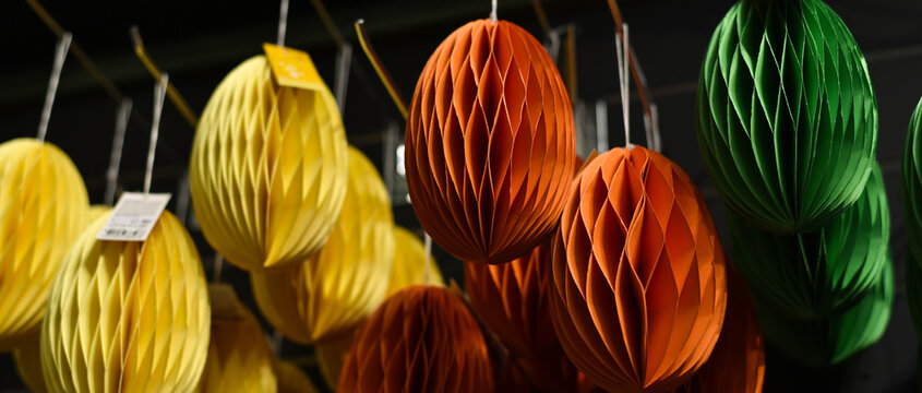 Origami Easter paper eggs hang in a decor store. Origami egg