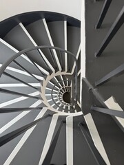 Spiral Staircase Symmetry: A gorgeous black and white view of a spiral staircase repeating down multiple floors with perfect symmetry. © Curiosity Photos