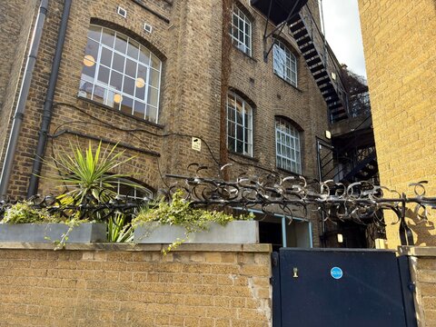 Barbed Wire Security: Intense barbed wire fencing protecting a small private enclave in an urban London setting.