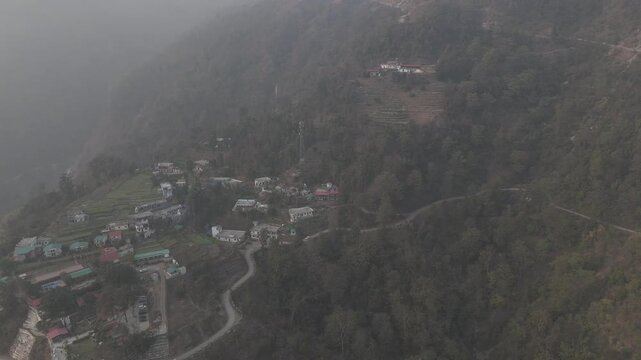 Aerial view of Kuee village in Tehri Garhwal, Uttarakhand, near Rishikesh, with the Ganga River flowing through Tota Ghati, surrounded by lower Himalayan hills and forests of sal, peepal, banyan.