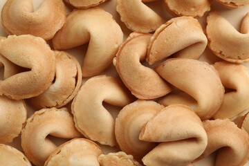 Fototapeta premium Tasty fortune cookies with predictions as background, top view