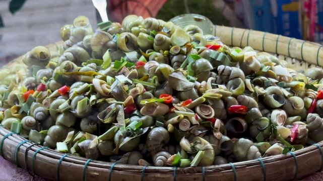 Steaming SStirfried Grilled Snails with Garlic at a Street Food Stall in Cambodia (Khyang)