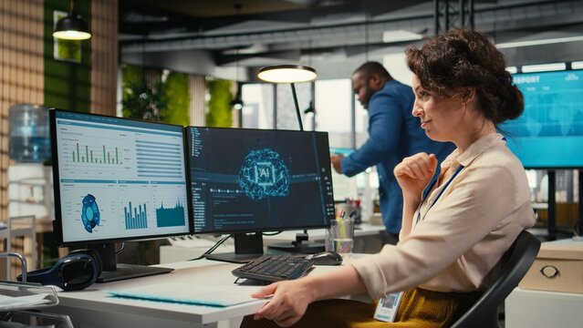 Female employee being pleased with AI integration success for efficiency recognition, using a synergy of data sharing and optimization models in a co working space. Progress prosperity.