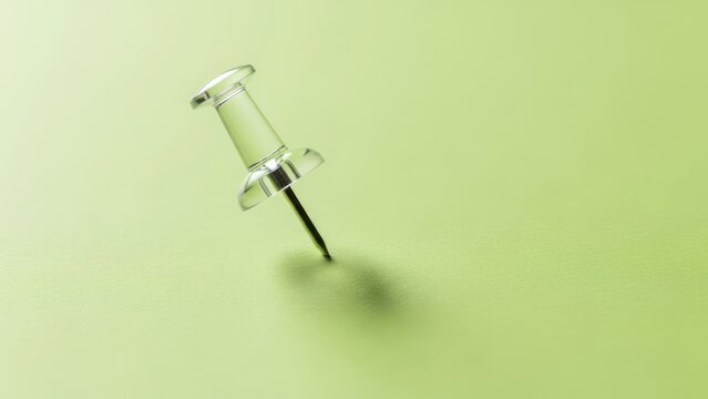 Transparent pushpin on green surface with shadow top down perspective office supply illustration for concepts like planning and organization