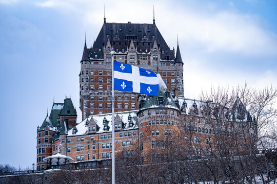 View of Quebec flag in front of Chateau Frontenac during winter. Quebec City, Canada - December 21, 2025.