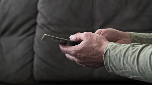 Transaction of New Israeli Shekel banknotes between two people person takes a stack of blue two hundred NIS bills from another individual.  cash payment and hand to hand transfer