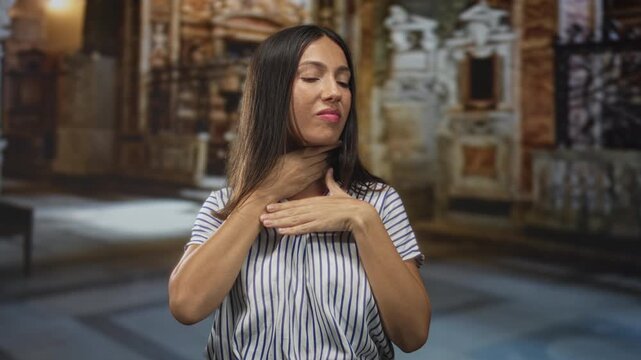 Hispanic woman with hands on throat inside a church building, eyes closed in apparent choking pose; panic plea.
