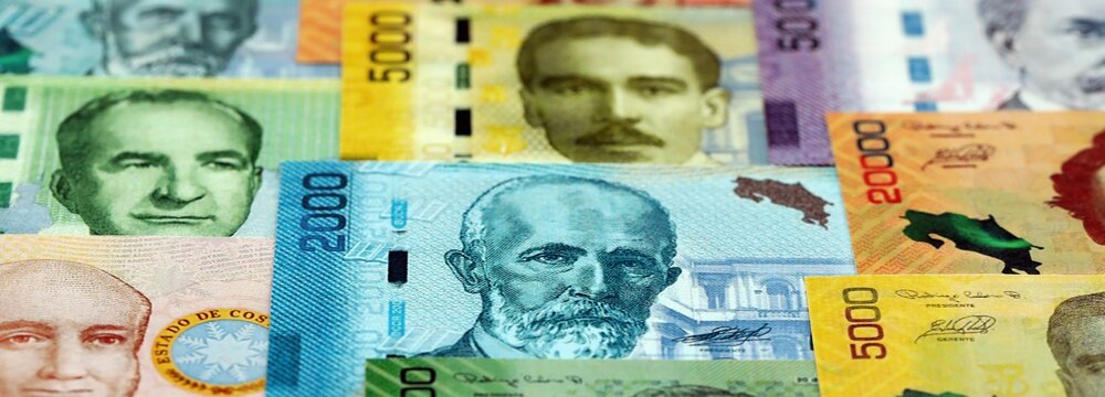 Costa Rican old and new colon money bills pile on table. Costa Rica banknotes of CRC currency close up. Concept of business, economy and banking in Costa Rica