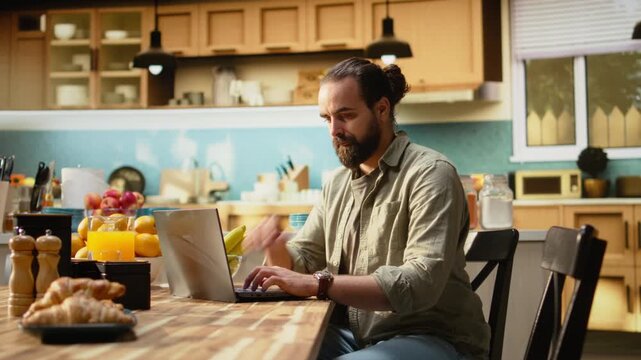 Adult worker, time on wristwatch, running late to the office, leaving home, being in a hurry to avoid delay. Male professional, looking at late hour sitting breakfast table in kitchen.