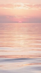 Obraz premium Beautiful soft pink sunset reflecting on calm ocean waves
