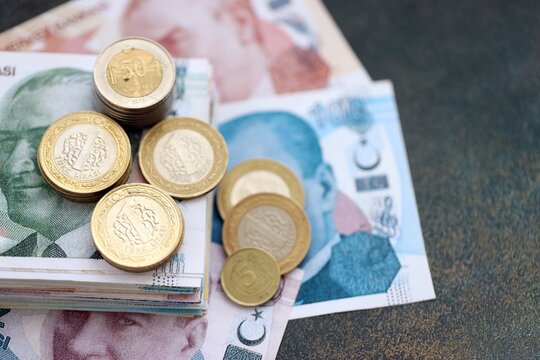 Turkish lira money bills and kurus coins pile on table. Turkey coins on banknotes of TRY currency close up. Concept of business, taxes and banking in Turkey