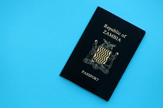 Zambian passport on table close up. Official identification document book for citizens of Zambia. Concept of travel and tourism in Zambia