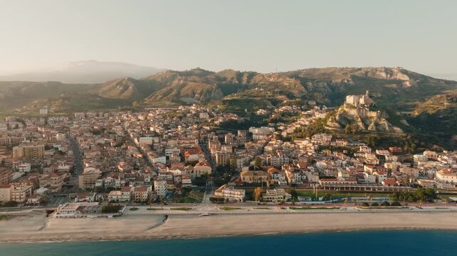 Medieval castle and touristic town of Roccella Ionica at a relaxing sunset