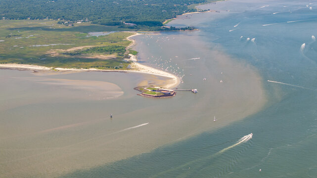 Aerial view of Fort Sumter National Monument near Charleston, South Carolina landscape with boats and shoreline during sunny day
