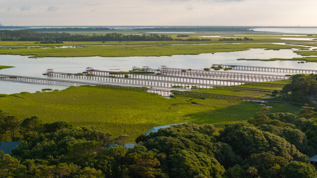 Panoramic Aerial view of marshes and pier boat docks in Folly Beach town near Charleston, South Carolina landscape during morning sunrise