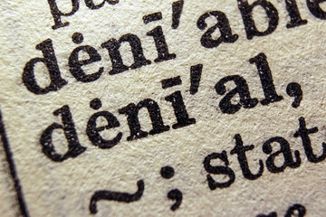 Word denial printed on dictionary page, macro close up