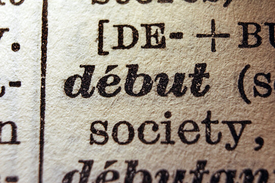 Word debut printed on dictionary page, macro close up