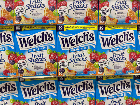 LOS ANGELES, CA, DEC 13, 2025: Stacked Welch's Mixed Fruit Snacks boxes at a warehouse store, 90-pouch bulk packs with colorful fruit imagery