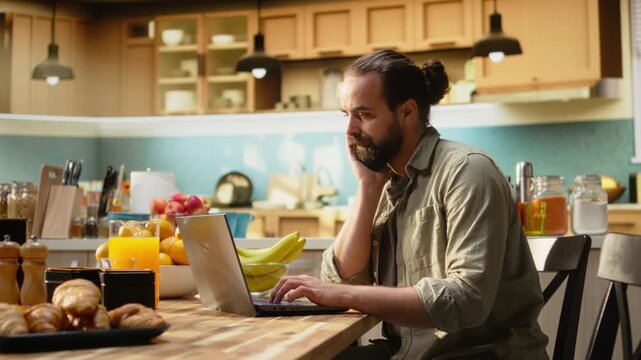 Demotivated dejected man with low energy and lack of motivation at laptop, working from home during monotonous slow workday. Hopeless indifferent adult tired of work, telecommuting.