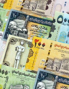 Yemeni rial paper banknotes pile on table. Yemen YER currency money bills in big amount. Concept of economics, taxation and banking in Yemen