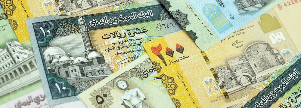 Yemeni rial paper banknotes pile on table. Yemen YER currency money bills in big amount. Concept of economics, taxation and banking in Yemen