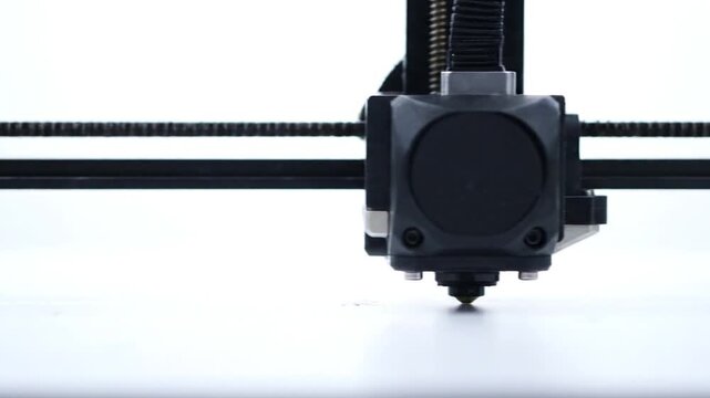 Close Up View Of 3D Printer Extruder On Print Bed In Action.