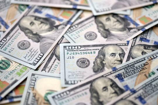 American dollars in one hundred banknotes. Lot of dollars close up. Stack of dollars and cash with a money background. US money and banknotes